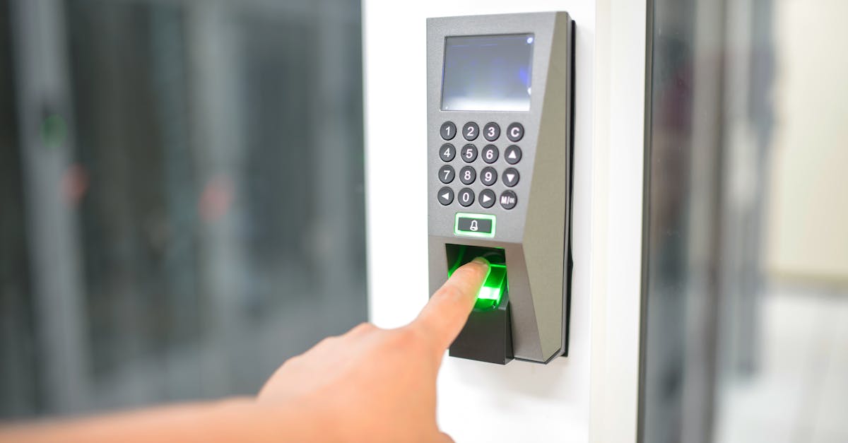 A person uses a fingerprint scanner for secure entry in a business setting.