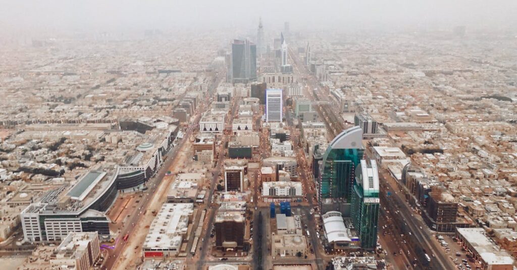 Aerial photograph of Riyadh's modern cityscape with iconic skyscrapers and bustling streets.